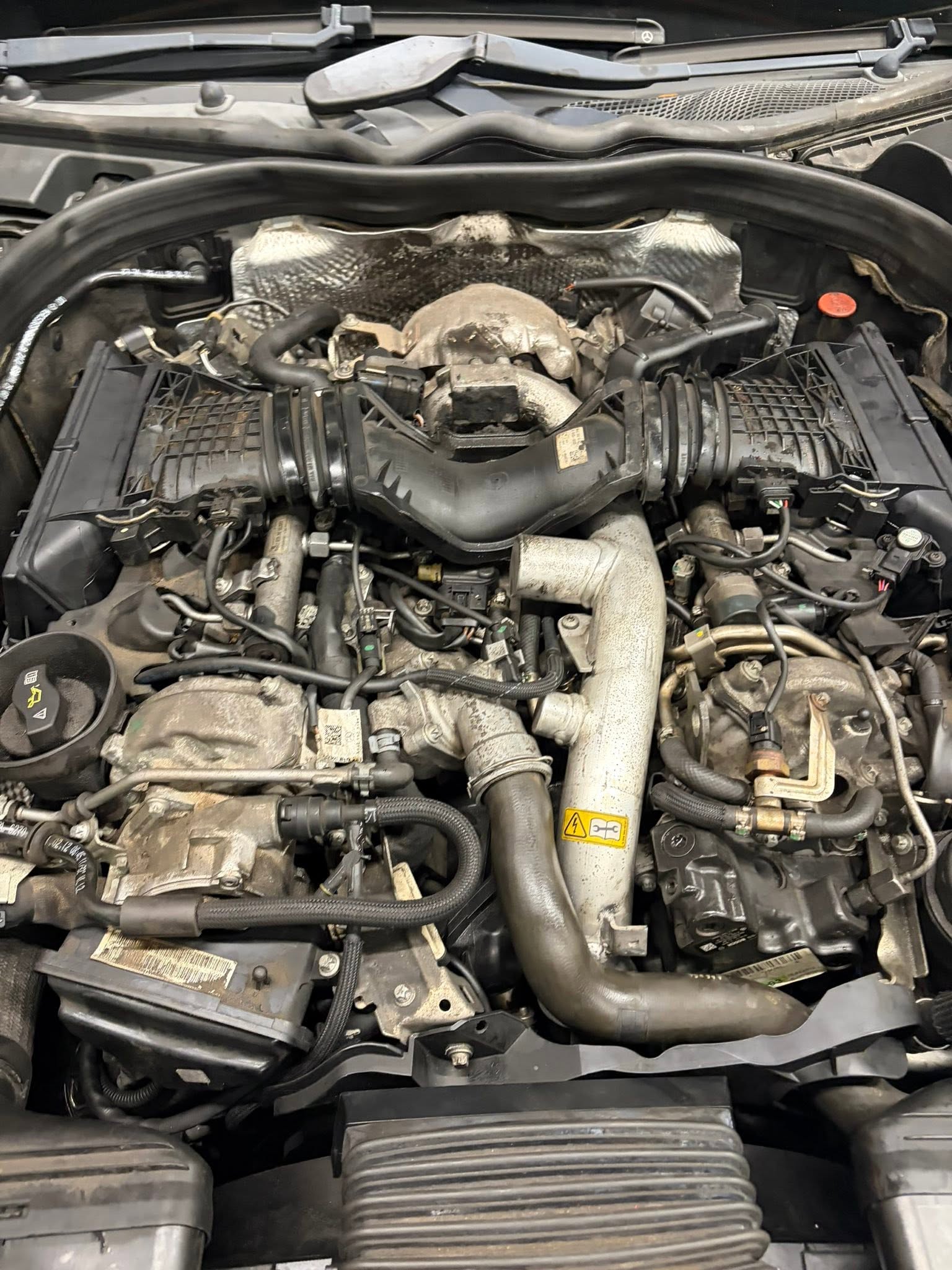 A diesel engine bay opened up mid-job in the workshop
